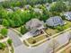 An aerial view shows the beautiful home, driveway, and landscaping at 1308 Green Oaks Pkwy, Holly Springs, NC 27540