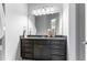 Elegant bathroom vanity with dark cabinetry, granite countertop, and decorative accents at 1308 Green Oaks Pkwy, Holly Springs, NC 27540