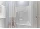 White bathtub and shower combo with white shower curtain and white walls at 1308 Green Oaks Pkwy, Holly Springs, NC 27540