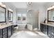 Bathroom with double vanities, soaking tub, glass shower, and modern fixtures at 1308 Green Oaks Pkwy, Holly Springs, NC 27540