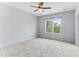 Bright bedroom with a ceiling fan and a large window overlooking the surrounding greenery at 1308 Green Oaks Pkwy, Holly Springs, NC 27540