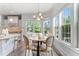 Charming breakfast nook features hardwood floors, natural light, and a comfortable dining set at 1308 Green Oaks Pkwy, Holly Springs, NC 27540