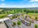 Stunning aerial view of the clubhouse, showcasing parking, landscaping, and the adjacent golf course at 1308 Green Oaks Pkwy, Holly Springs, NC 27540
