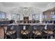 Elegant dining room featuring a large table set for a formal gathering with a fireplace in background at 1308 Green Oaks Pkwy, Holly Springs, NC 27540