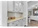 Elegant kitchen features white cabinets with glass doors, granite countertops, and stylish backsplash at 1308 Green Oaks Pkwy, Holly Springs, NC 27540
