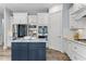 Spacious kitchen island with dark blue cabinets, granite counters, and stainless steel appliances at 1308 Green Oaks Pkwy, Holly Springs, NC 27540