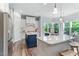 Gourmet kitchen boasts white cabinets, stainless steel appliances, an island, and a separate breakfast bar at 1308 Green Oaks Pkwy, Holly Springs, NC 27540