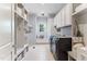 Organized laundry room with modern washer/dryer, ample storage, and convenient folding area at 1308 Green Oaks Pkwy, Holly Springs, NC 27540