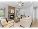 Inviting living room with a stone fireplace, hardwood floors, and comfortable seating arrangement at 1308 Green Oaks Pkwy, Holly Springs, NC 27540