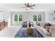 Bright living room with neutral decor, plush seating, and a stylish area rug on carpeted floor at 1308 Green Oaks Pkwy, Holly Springs, NC 27540