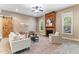 Inviting living room with a wooden accent wall and fireplace offering a cozy gathering space at 1308 Green Oaks Pkwy, Holly Springs, NC 27540