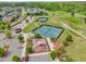 Aerial view of playground, tennis courts, and parking nestled among trees in a Gathering-friendly community at 1308 Green Oaks Pkwy, Holly Springs, NC 27540