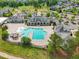 A sparkling swimming pool is surrounded by lush landscaping, a lounge area and clubhouse at 1308 Green Oaks Pkwy, Holly Springs, NC 27540