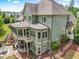 Stunning aerial view of the home's rear exterior with a screened porch and patio area at 1308 Green Oaks Pkwy, Holly Springs, NC 27540