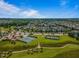 Aerial view of tennis courts, walking paths, and a playground surrounded by homes and green space at 1308 Green Oaks Pkwy, Holly Springs, NC 27540