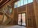 View of the interior with staircase and large windows, showcasing natural light and open design at 1500 Ridge Rd, Raleigh, NC 27607