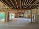 Spacious unfinished living room with a fireplace and staircase at 1500 Ridge Rd, Raleigh, NC 27607