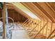Unfinished attic exhibiting wooden framework, insulation, and visible construction elements at 155 Diamond Creek Dr, Zebulon, NC 27597