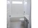 This bathroom features a tub/shower combo and a tiled floor at 155 Diamond Creek Dr, Zebulon, NC 27597