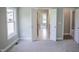 This spacious bedroom has an ensuite bath, large window for natural light, and neutral-colored carpet flooring at 155 Diamond Creek Dr, Zebulon, NC 27597
