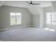 Large bedroom with plush carpet, ceiling fan, multiple windows and dormer adding character at 155 Diamond Creek Dr, Zebulon, NC 27597