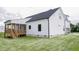 View of the back of the house with a wooden porch and well-maintained backyard at 155 Diamond Creek Dr, Zebulon, NC 27597