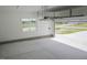 Clean garage featuring sealed concrete floor, automatic door and lots of space for storage at 155 Diamond Creek Dr, Zebulon, NC 27597