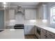 This modern kitchen boasts white cabinets, subway tile backsplash, stainless hood, and an eat-in breakfast area at 155 Diamond Creek Dr, Zebulon, NC 27597