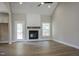 Cozy living room featuring a fireplace, vaulted ceiling, and hardwood floors, creating an inviting atmosphere at 155 Diamond Creek Dr, Zebulon, NC 27597
