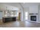 An open-concept living space with a modern kitchen, fireplace, and wood floors, perfect for entertaining at 155 Diamond Creek Dr, Zebulon, NC 27597