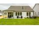 Spacious backyard featuring a covered patio and a lush green lawn at 1606 Garden Park Cir, Fuquay Varina, NC 27526