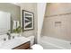 Cozy bathroom with tiled walls, a tub-shower combo, and contemporary fixtures at 1606 Garden Park Cir, Fuquay Varina, NC 27526