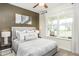 Comfortable bedroom with a ceiling fan, a large window, and soft, neutral tones at 1606 Garden Park Cir, Fuquay Varina, NC 27526