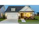 Charming two-story home with a well-maintained lawn, covered porch, and attached garage at 1606 Garden Park Cir, Fuquay Varina, NC 27526