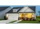 Charming home with a two-car garage, inviting front porch, and professional landscaping at 1606 Garden Park Cir, Fuquay Varina, NC 27526