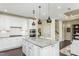 Bright kitchen with granite countertops, stainless steel appliances and modern pendant lighting at 1606 Garden Park Cir, Fuquay Varina, NC 27526