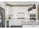 Contemporary kitchen featuring granite countertops, stainless steel appliances, and sleek cabinetry at 1606 Garden Park Cir, Fuquay Varina, NC 27526