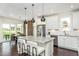 Modern kitchen with stainless steel appliances, center island and breakfast bar overlooking the dining area at 1606 Garden Park Cir, Fuquay Varina, NC 27526