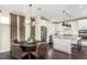 Bright kitchen and dining area with stainless steel appliances, modern lighting and seating at 1606 Garden Park Cir, Fuquay Varina, NC 27526