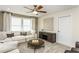 Cozy living room featuring comfortable seating, neutral decor, and a ceiling fan at 1606 Garden Park Cir, Fuquay Varina, NC 27526