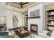 Inviting living room featuring a fireplace, ceiling fan, stylish decor, and comfortable seating at 1606 Garden Park Cir, Fuquay Varina, NC 27526
