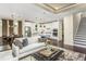 Open-concept living space with modern kitchen, comfortable seating, and elegant finishes at 1606 Garden Park Cir, Fuquay Varina, NC 27526