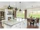 Open concept kitchen and living space, featuring modern finishes and outdoor view at 1606 Garden Park Cir, Fuquay Varina, NC 27526