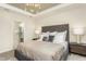 Bright main bedroom featuring a window view, soft carpet, and contemporary furniture at 1606 Garden Park Cir, Fuquay Varina, NC 27526