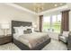 Beautifully appointed main bedroom with a large window and a decorative headboard at 1606 Garden Park Cir, Fuquay Varina, NC 27526