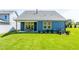 Well-maintained backyard with a covered patio and lush green lawn at 1614 Garden Park Cir, Fuquay Varina, NC 27526