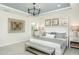 Bright bedroom featuring stylish decor, a large window, and a glimpse into the bathroom at 1614 Garden Park Cir, Fuquay Varina, NC 27526