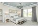 Beautiful bedroom featuring a black chandelier, many windows, and neutral decor at 1614 Garden Park Cir, Fuquay Varina, NC 27526