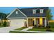Charming home with a two-car garage, manicured lawn, and inviting front porch at 1614 Garden Park Cir, Fuquay Varina, NC 27526