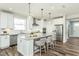 Stylish kitchen with white cabinetry, stainless steel appliances, and a center island with seating at 1614 Garden Park Cir, Fuquay Varina, NC 27526
